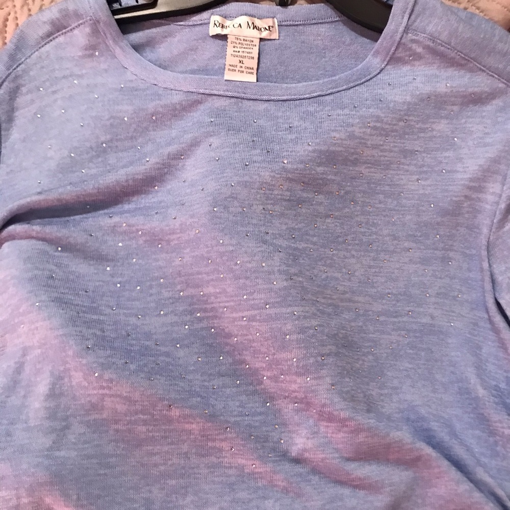 Long sleeved light blue shirt with some stones